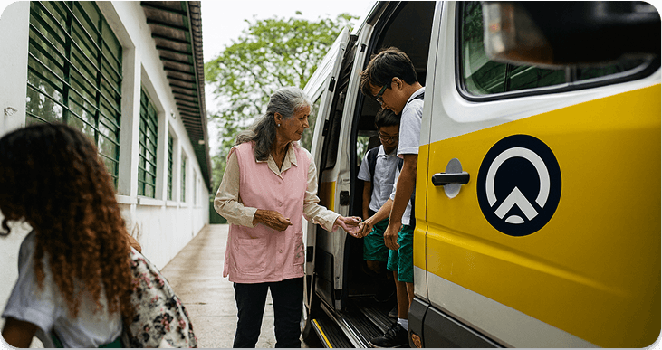 Driver helping students board a van